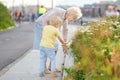 Beautiful granny and her little grandchild walking together in park. Grandma and grandson. Quality family time. Explorers of the Royalty Free Stock Photo