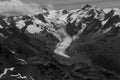 Beautiful grayscale shot of snowy rocky mountains Royalty Free Stock Photo