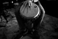 Beautiful grayscale view of Djembe drum player's hand on drum