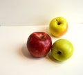 A great composition of three fresh and shiny green, red and yellow apples on a triangular composition on a white background Royalty Free Stock Photo