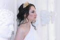 Beautiful Greek goddess woman closeup on the white ancient ruins background