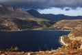 Beautiful greek landscape: seashore with mountains and clouds Royalty Free Stock Photo