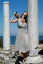 Beautiful Greek young girl holding a vessel