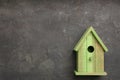 Beautiful green bird house on grey background, space for text Royalty Free Stock Photo