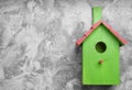 Beautiful green bird house on light grey background, space for text Royalty Free Stock Photo