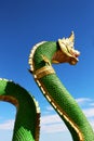 Beautiful Green colors of Praya Nark or Naga in Thai temple with colorful sky and sun flare effect on sunrise time Royalty Free Stock Photo