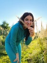 A beautiful girl in a field playing with plants. The concept of walking in nature, freedom and an eco-friendly lifestyle Royalty Free Stock Photo