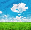 Beautiful green field and blue sky on grunge crumpled paper Royalty Free Stock Photo