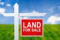 Beautiful green field and blue sky with LAND FOR SALE sign. Royalty Free Stock Photo