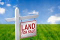 Beautiful green field and blue sky with LAND FOR SALE sign. Royalty Free Stock Photo