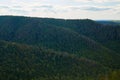 Beautiful green forest against the blue sky with clouds. Natural Park Royalty Free Stock Photo