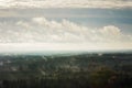 Beautiful green forests and fields pictured from airplane window with blue sky and clouds. Countryside view from airplane in the Royalty Free Stock Photo