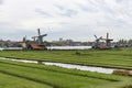 Beautiful Zaanse Schans Windmill Landscape on a Cloudy Autumn Day with a Green Grass Field in the Netherlands Royalty Free Stock Photo