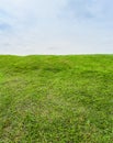 Beautiful Green grass field on small hill and blue sky Royalty Free Stock Photo