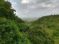 Beautiful green landscape view of a hill from the top of a tree in a forest Royalty Free Stock Photo