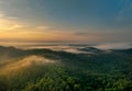 Beautiful green mountain landscape with morning sunrise sky and fog. Aerial view of green trees in tropical mountain forests and Royalty Free Stock Photo