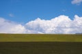 Beautiful green mountain valley with blue cloudy sky on background. Spring farm field landscape. Outdoor landscape. Sunset light. Royalty Free Stock Photo