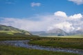 Beautiful green mountain valley with river and blue cloudy sky on background. Spring farm field landscape. Outdoor landscape. Suns Royalty Free Stock Photo