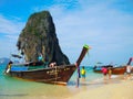 Beautiful green ocean water with wooden sightseeing boat rocky mountain in the sea, Krabi, Thailand.