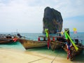 Beautiful green ocean water with wooden sightseeing boat rocky mountain in the sea, Krabi, Thailand.