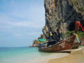 Beautiful green ocean water with wooden sightseeing boat rocky mountain in the sea, Krabi, Thailand.