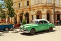 Beautiful green retro car in cuban town Royalty Free Stock Photo