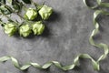 Beautiful green roses and ribbon on grey background Royalty Free Stock Photo