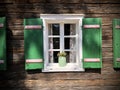 Beautiful green shutters and white window on typical and traditional austrian alpine wooden house - Salzkammergut Royalty Free Stock Photo