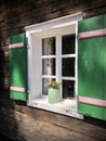 Beautiful green shutters and white window on typical and traditional austrian alpine wooden house - Salzkammergut Royalty Free Stock Photo