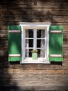 Beautiful green shutters and white window on typical and traditional austrian alpine wooden house - Salzkammergut Royalty Free Stock Photo