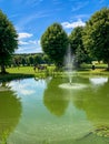 Beautiful green summer park landscape with a pond with water fountain, Sigtuna Sweden. Royalty Free Stock Photo