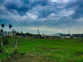 Beautiful Green Village Market Place on Evening with Dark Monsoon Passing Clouds Background Royalty Free Stock Photo