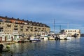 Grey house and pier with boats and yachts in North End district in Boston