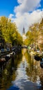 Beautiful canal in Amsterdam with the Soutern church Zuiderkerk at sunset in Fall