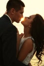 Beautiful groom and bride in wedding clothes posing on sea coast Royalty Free Stock Photo