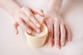 Beautiful groomed woman`s hands with body and skin cream on a light background Royalty Free Stock Photo