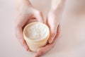 Beautiful groomed woman`s hands with body and skin cream on a light background Royalty Free Stock Photo