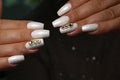 Beautiful groomed woman& x27;s hands, nails on the light gray background