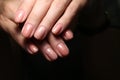 Beautiful groomed woman& x27;s hands, nails on the light gray background