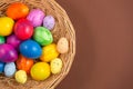 Beautiful group Easter eggs in the spring of easter day, red eggs, blue, purple and yellow in Wooden basket on the brown