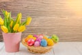 Beautiful group Easter eggs in the spring of easter day, red eggs, blue, purple and yellow in Wooden basket on the table