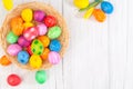 Beautiful group Easter eggs in the spring of easter day, red eggs, blue, purple and yellow in Wooden basket with tulips on the