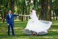 Beautiful guy and girl, bride in a white wedding dress, groom in a classic blue suit against a nature background. Wedding, family Royalty Free Stock Photo