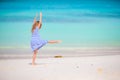 Beautiful gymnastic little girl doing her exercises on the beach Royalty Free Stock Photo