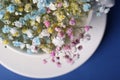 Beautiful gypsophila flowers in white cup on blue background, top view Royalty Free Stock Photo
