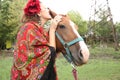 Beautiful gypsy girl in bright clothes with a horse on a farm Royalty Free Stock Photo