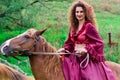 Beautiful gypsy girl riding a horse Royalty Free Stock Photo