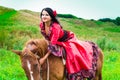 Beautiful gypsy girl riding a horse Royalty Free Stock Photo