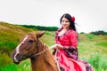 Beautiful gypsy girl riding a horse Royalty Free Stock Photo