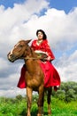 Beautiful gypsy girl riding a horse Royalty Free Stock Photo